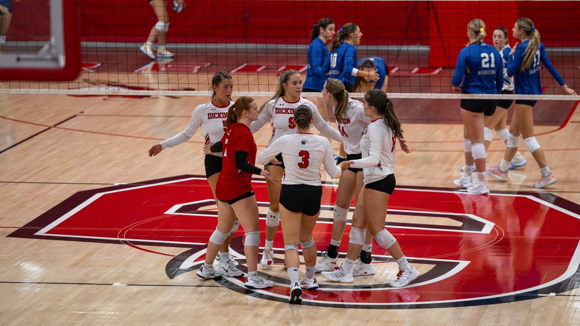 Volleyball group celebration after winning a point against Misericordia University on 9-12-26