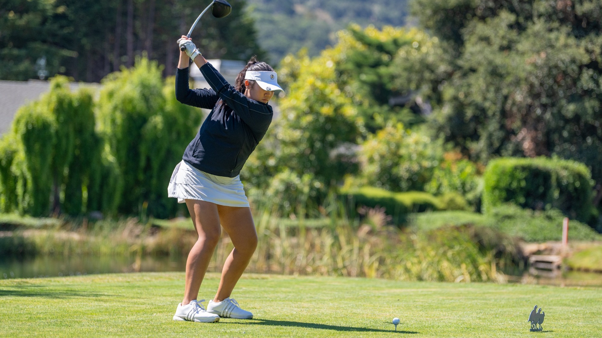 Faith Guevara begins a tee shot