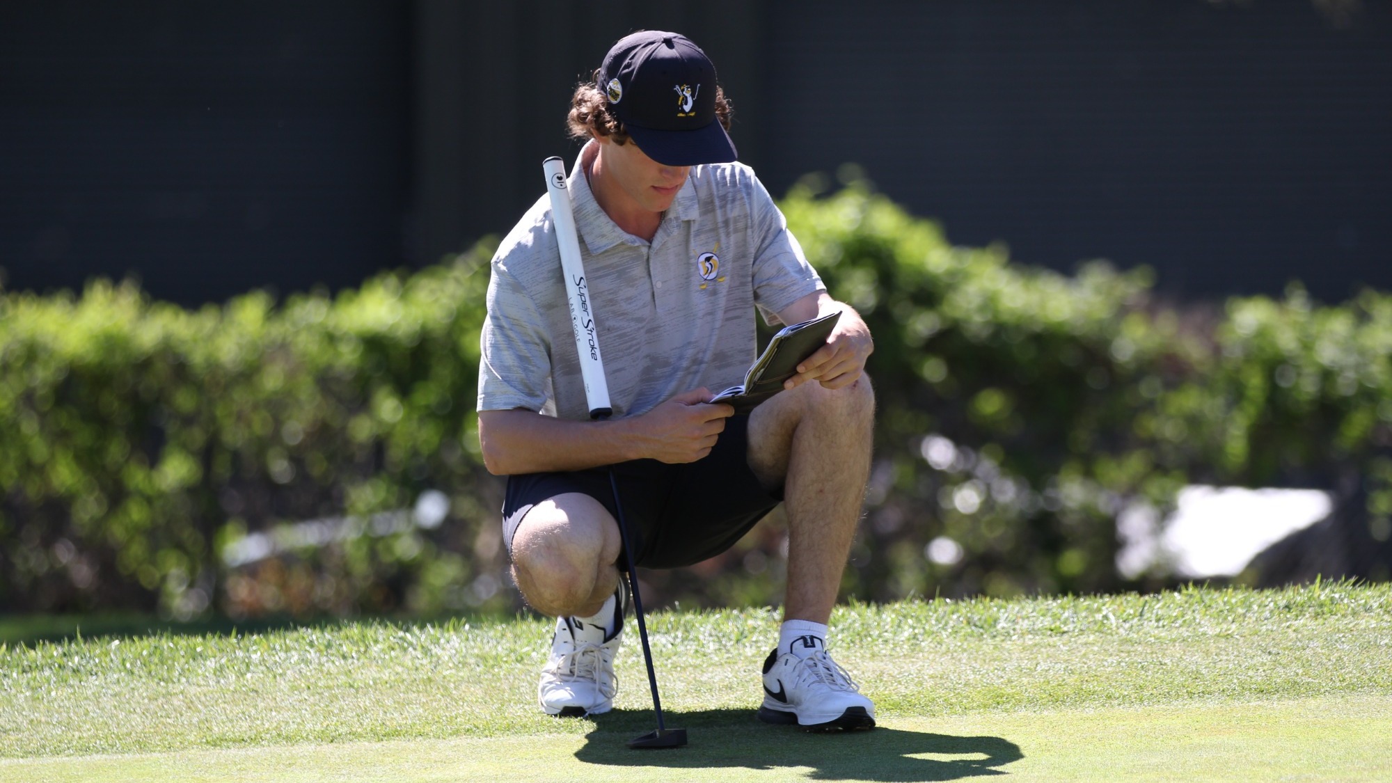 Jerred Scott reviews his notes on the green