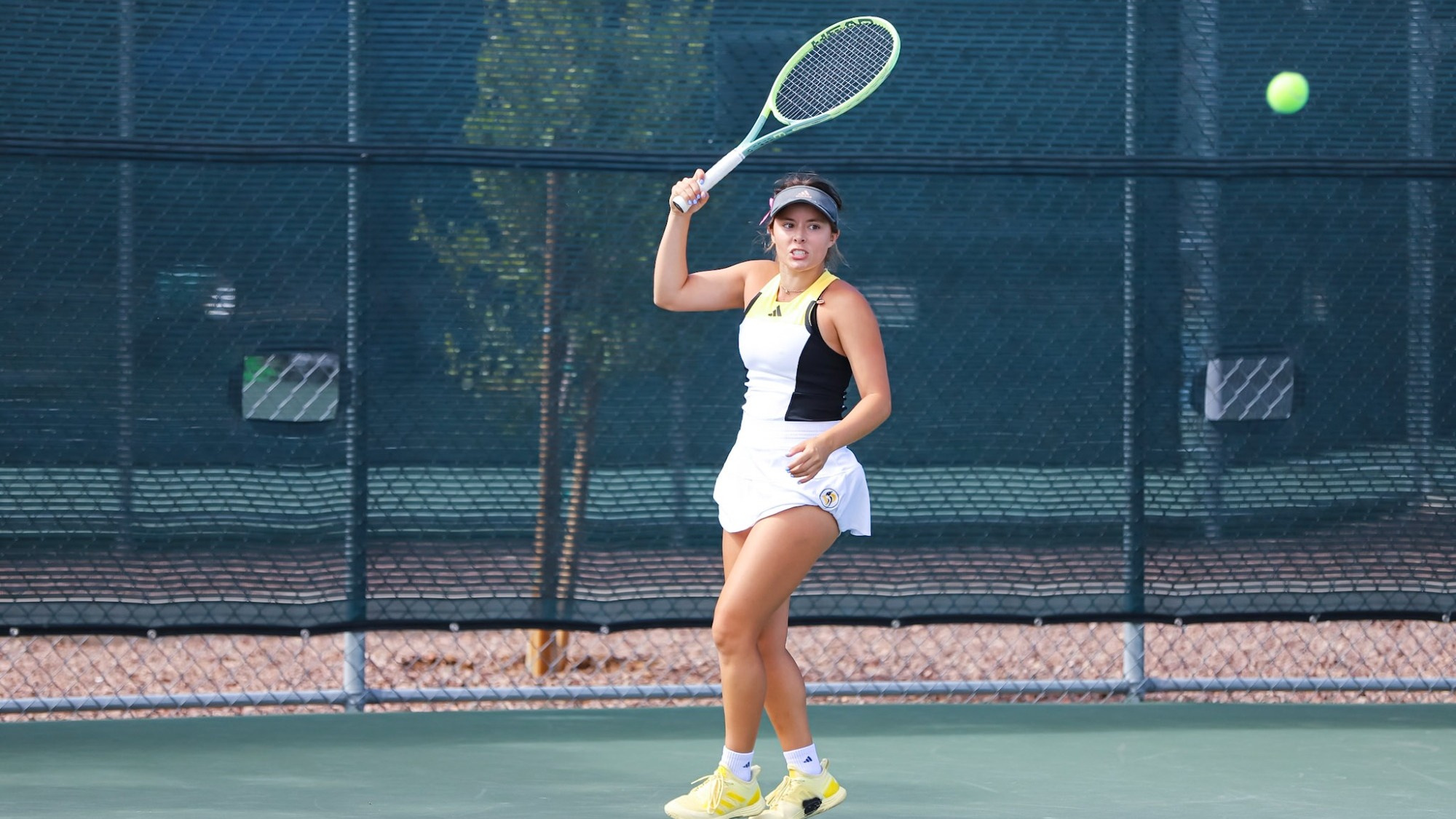 Sofia Acuna scores on a forehand return against Stanislaus State
