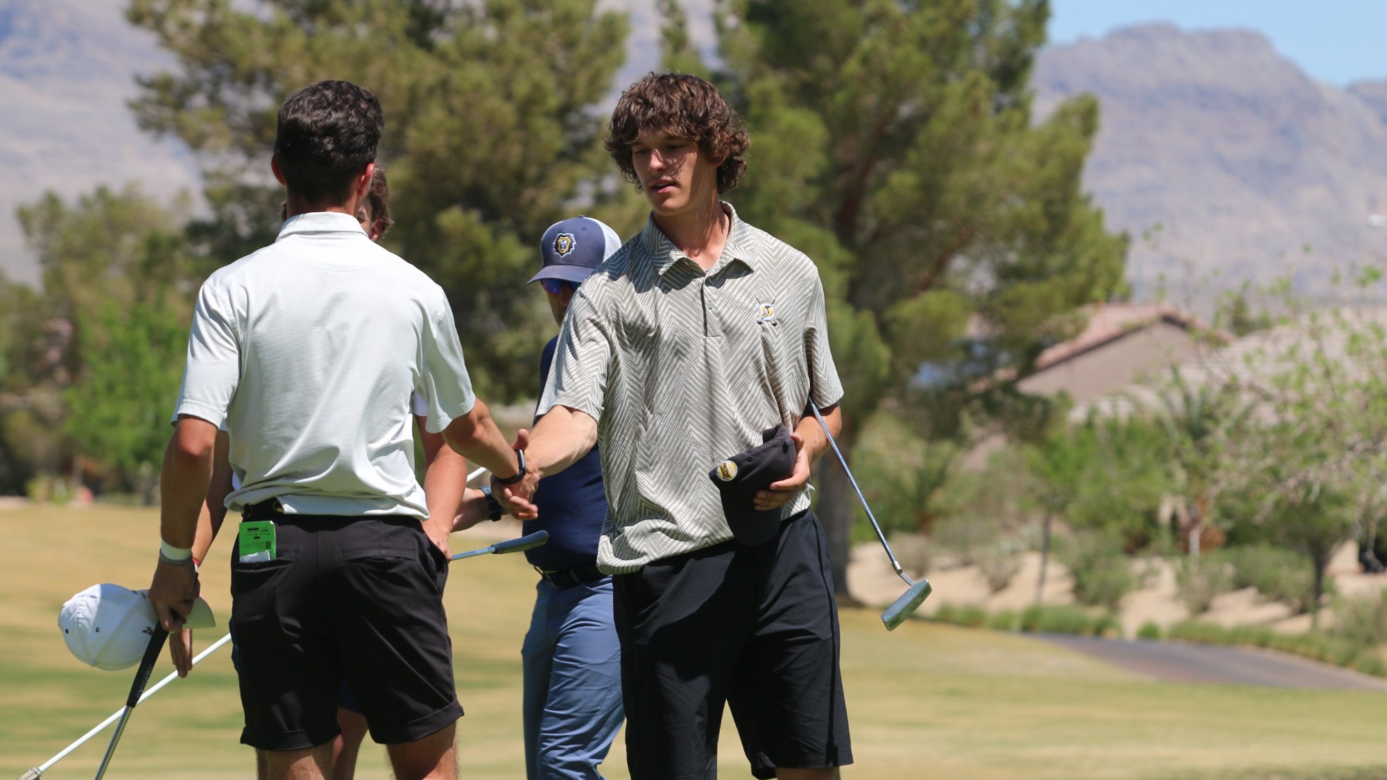 Jerred Scott shakes hands with his opponent after final hole of round 1 at PacWest Championships