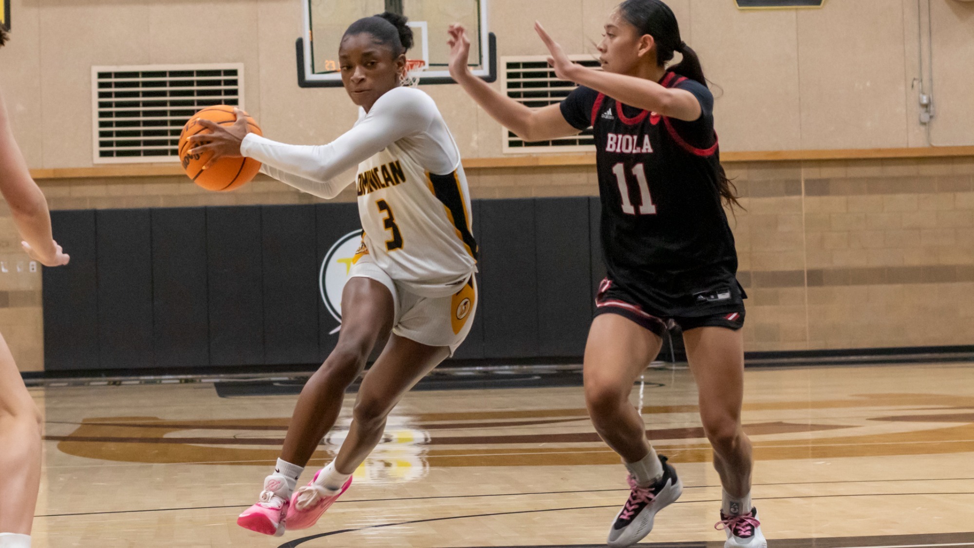 Kaylyn Buchanon drives to the hoop against Biola