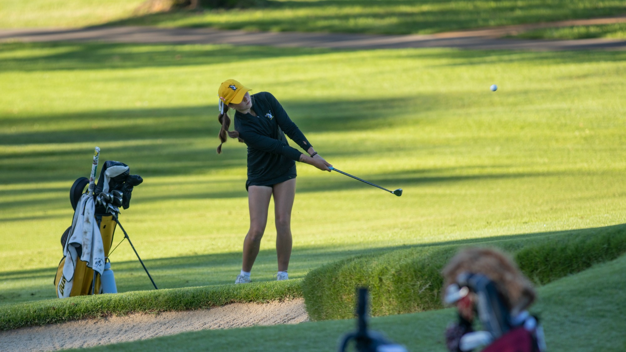 Madi Whitney chips a ball onto the green at The Big Freeze