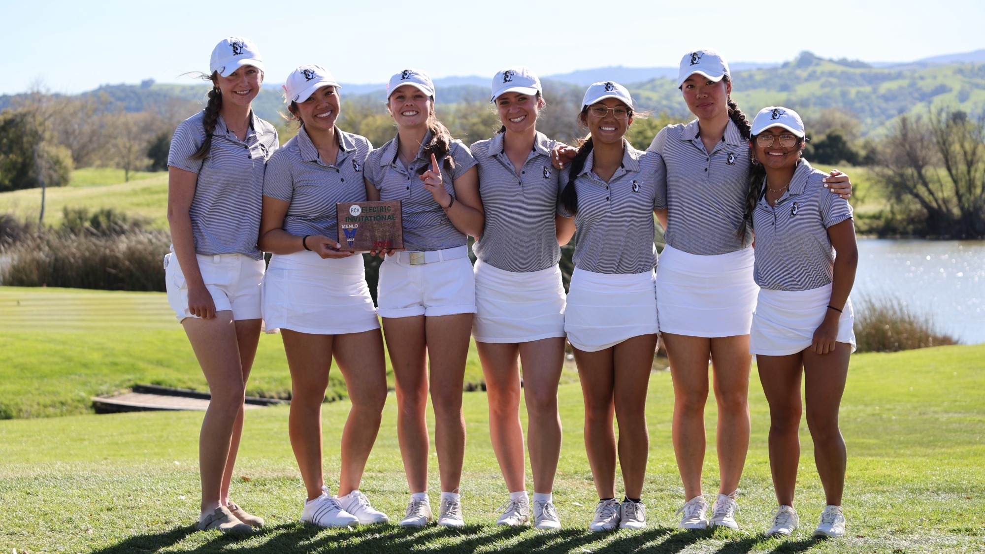 Dominican poses with its team championship plaque