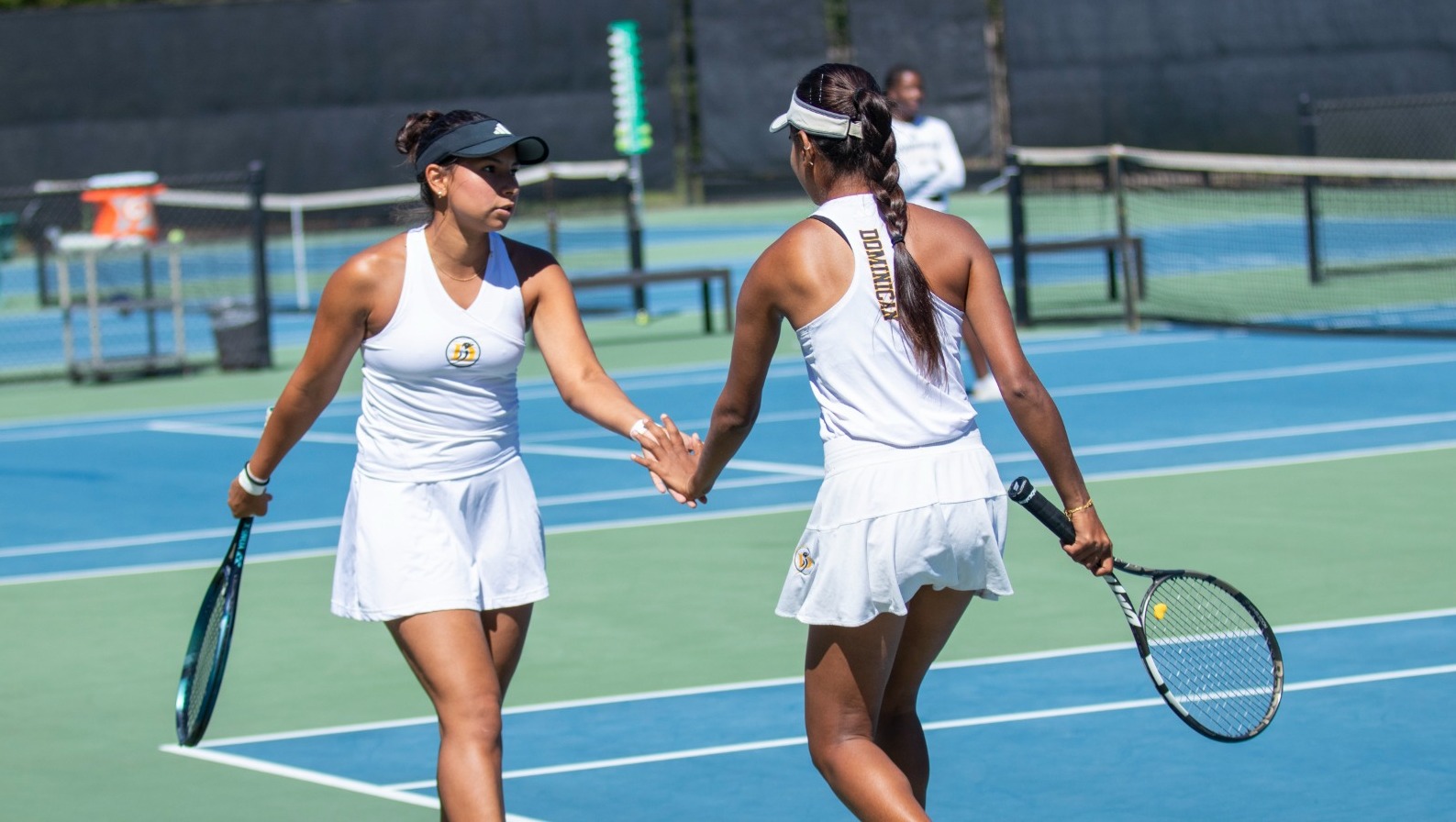 Ana Rios and Deepalakshmi Vanaraja celebrate a point on senior day