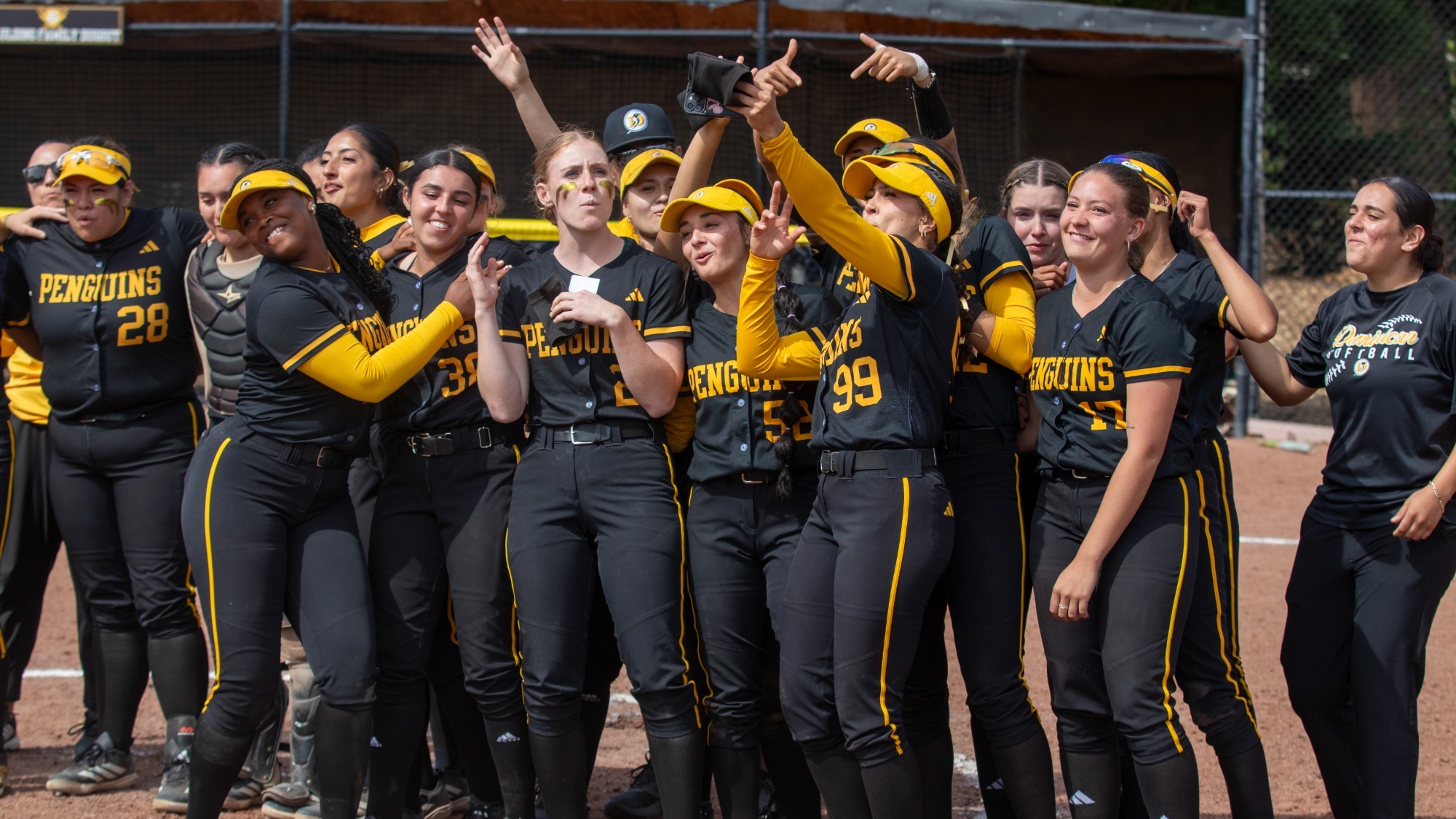 Dominican softball sings the fight song as they celebrate a sweep of Vanguard