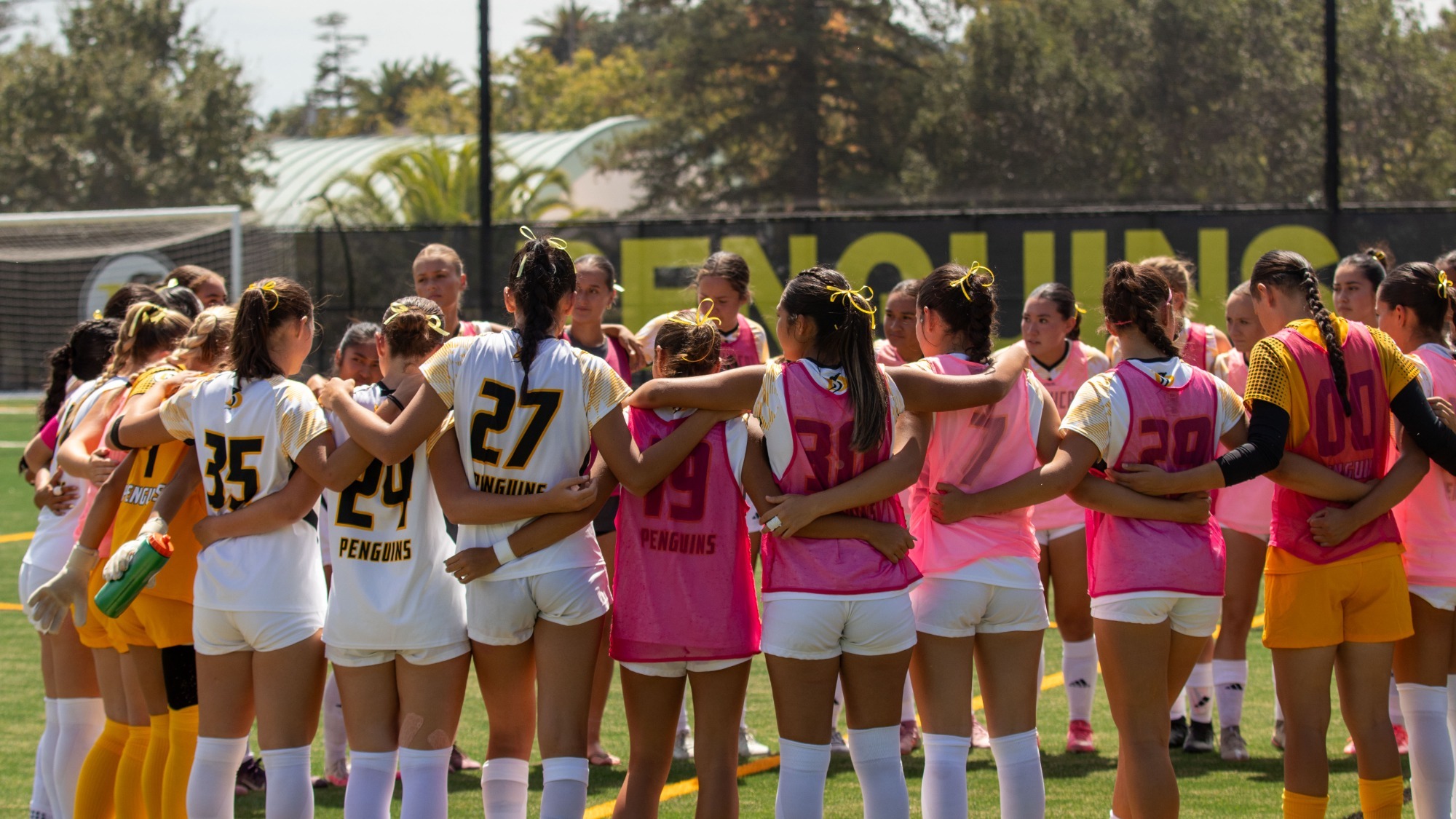 Dominican huddles at the half to discuss tactics against NNU