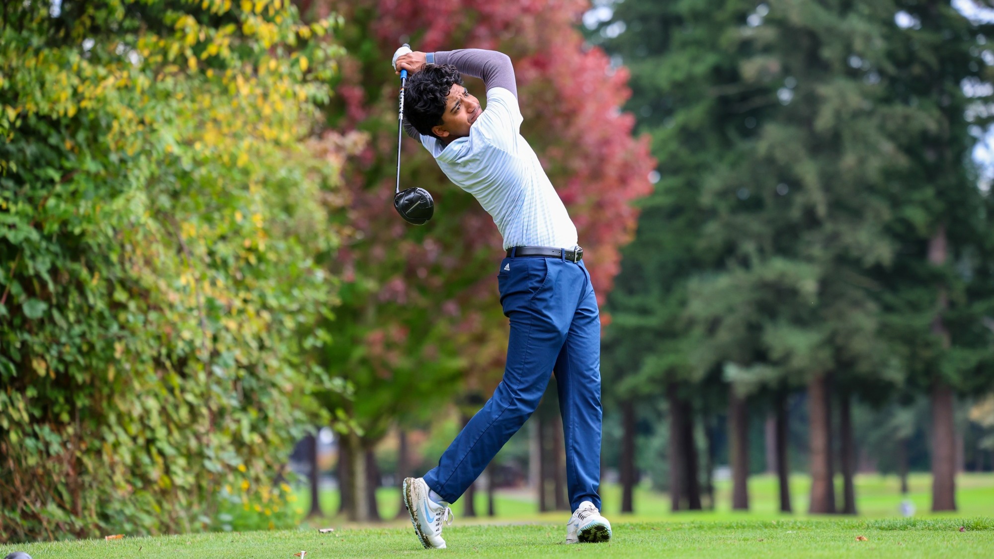 Miki Khursheed looks down the fairway after teeing off