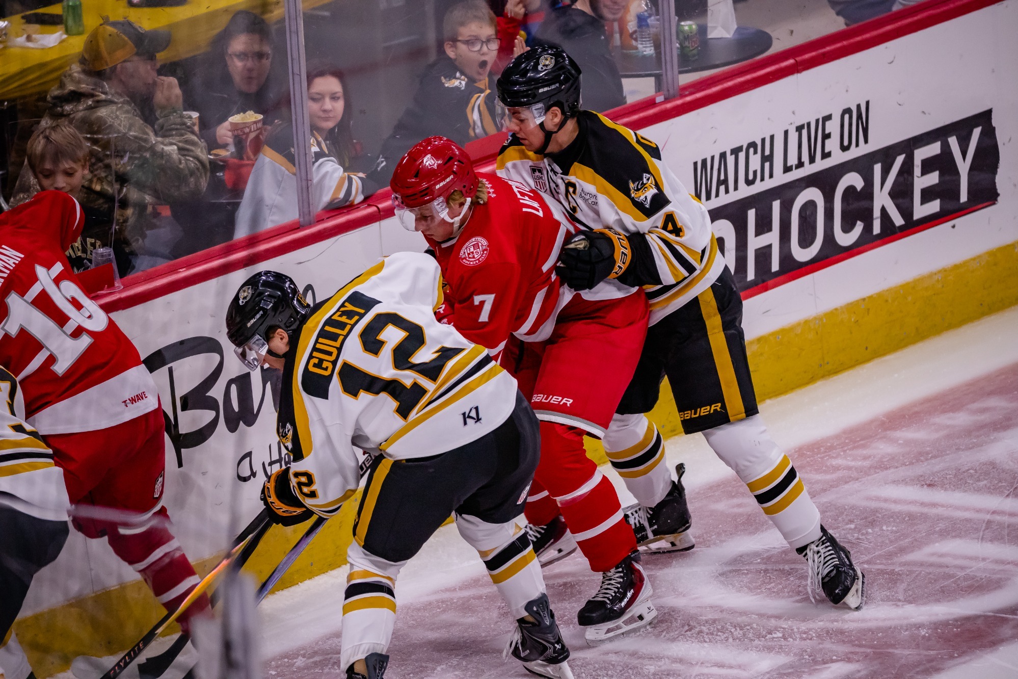 Lafton battles for loose puck in Green Bay 