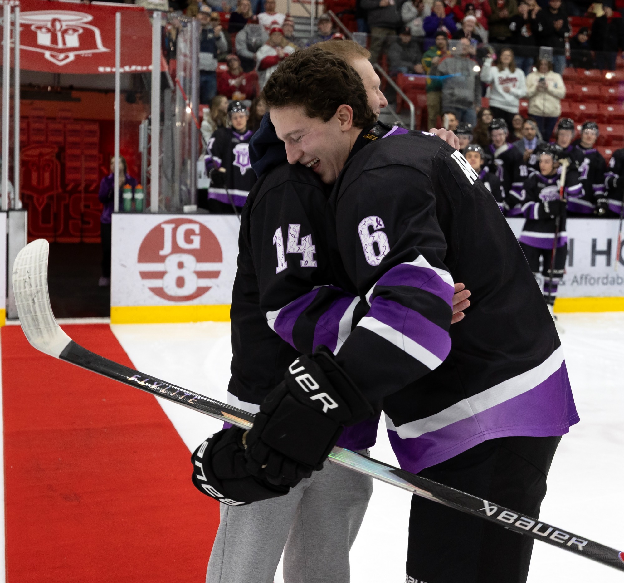 Charlie Arend hugs best friend on Stick it to Cancer Night