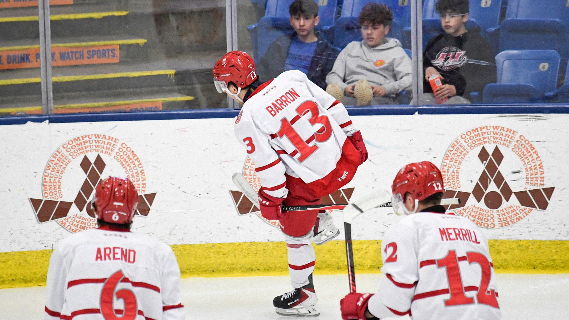 Barron celebrates goal with Arend and Merrill on Feb. 14 at USA