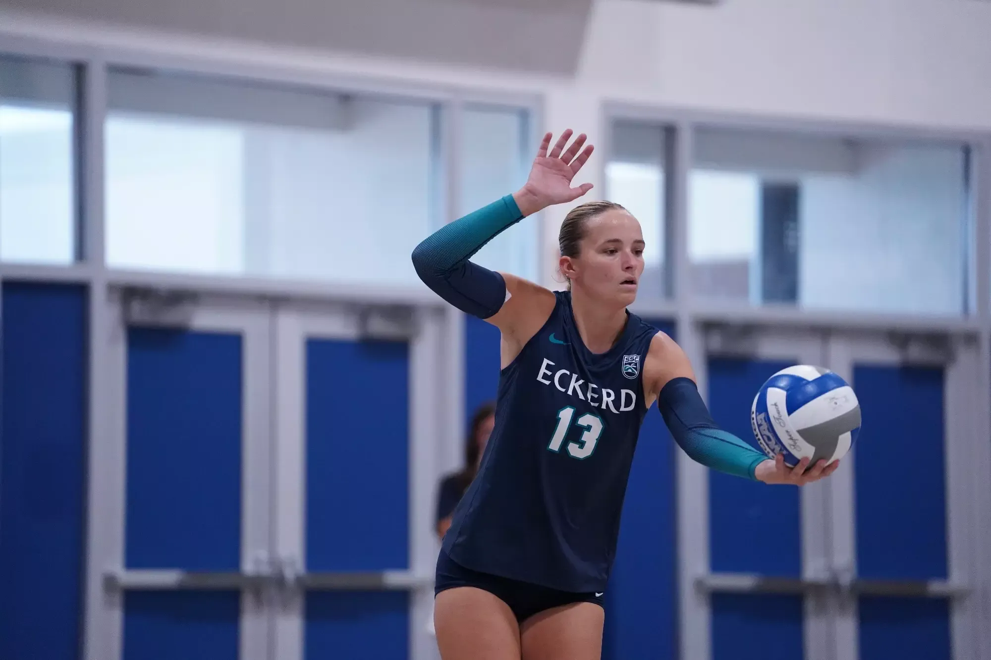Eckerd player prepares to serve ball