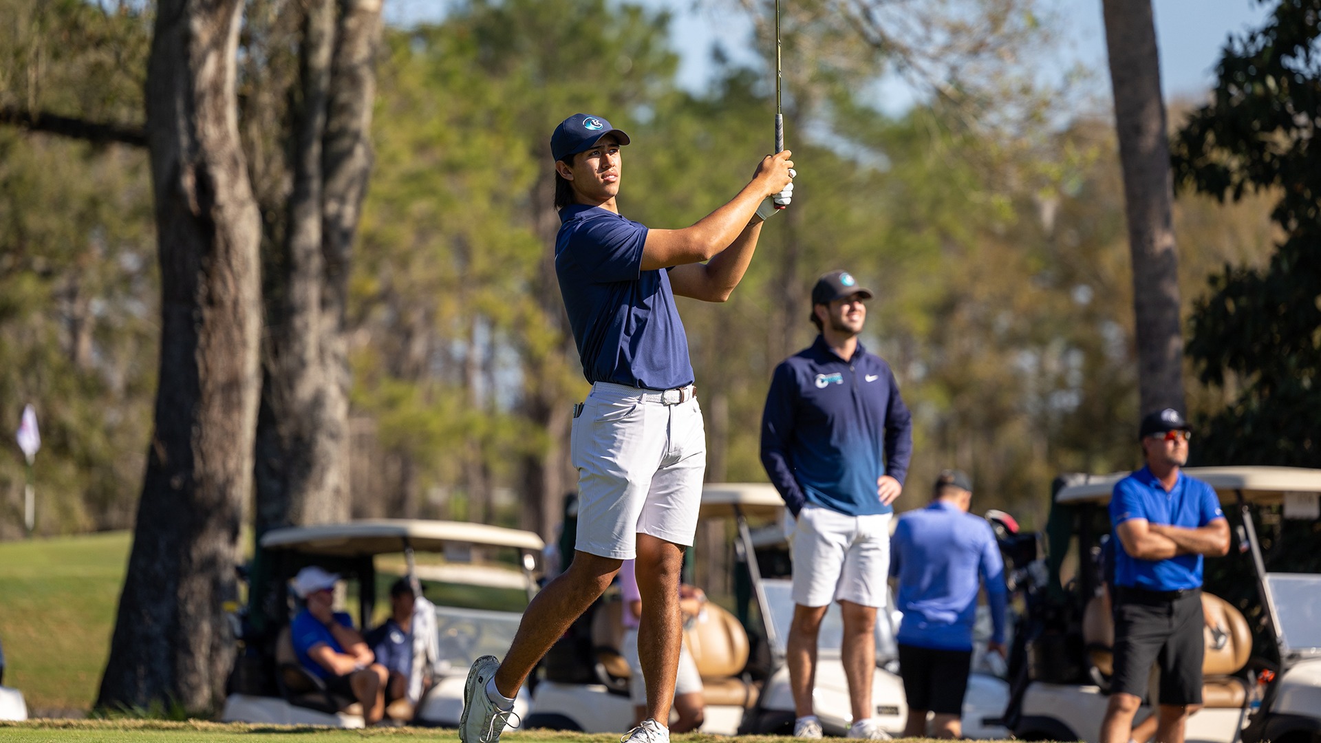 men's golfer hitting finish of tee shot 