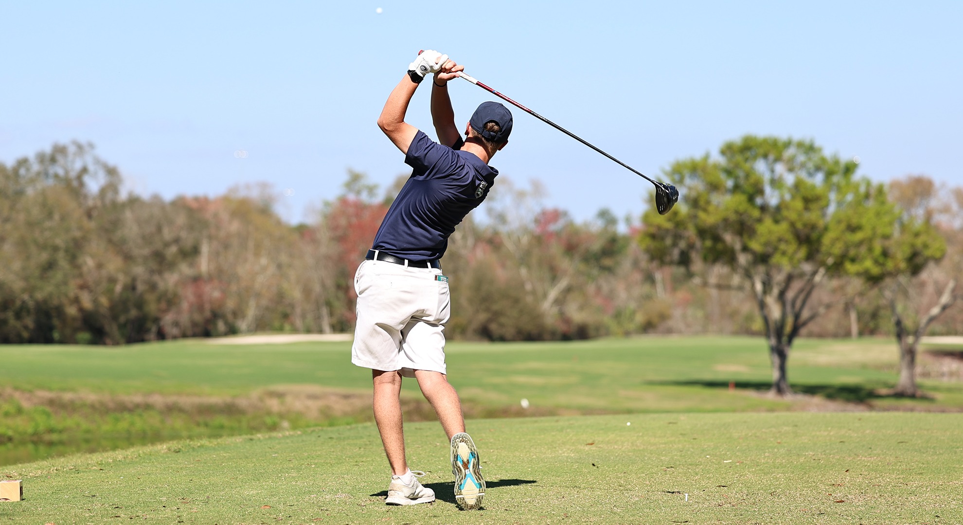men's golfer hitting a tee shot 