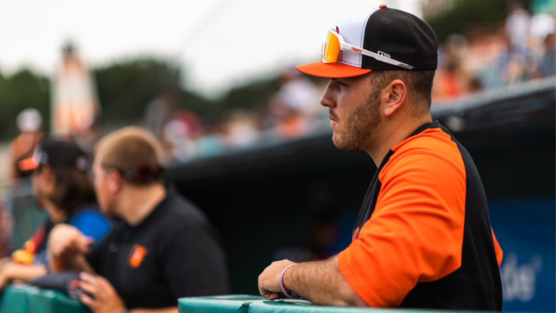 baseball coach standing in dugout 
