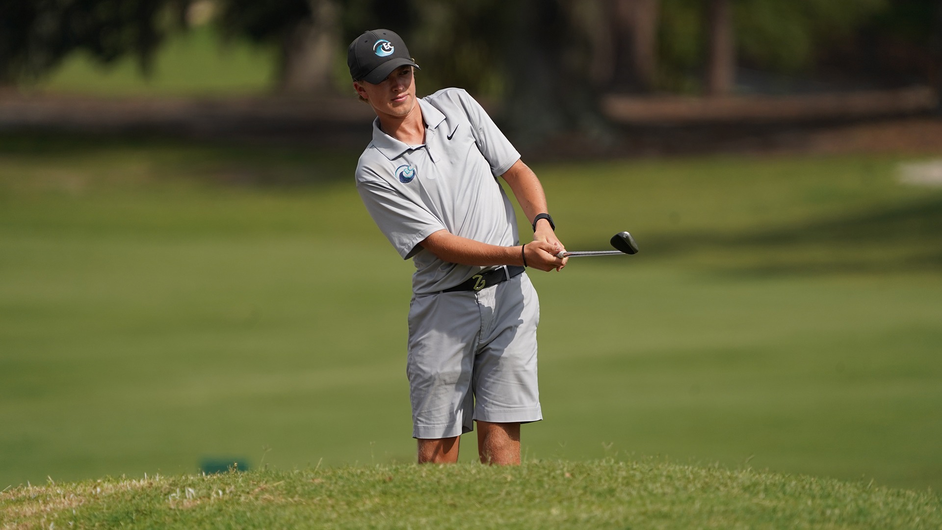 golfer hitting a chip