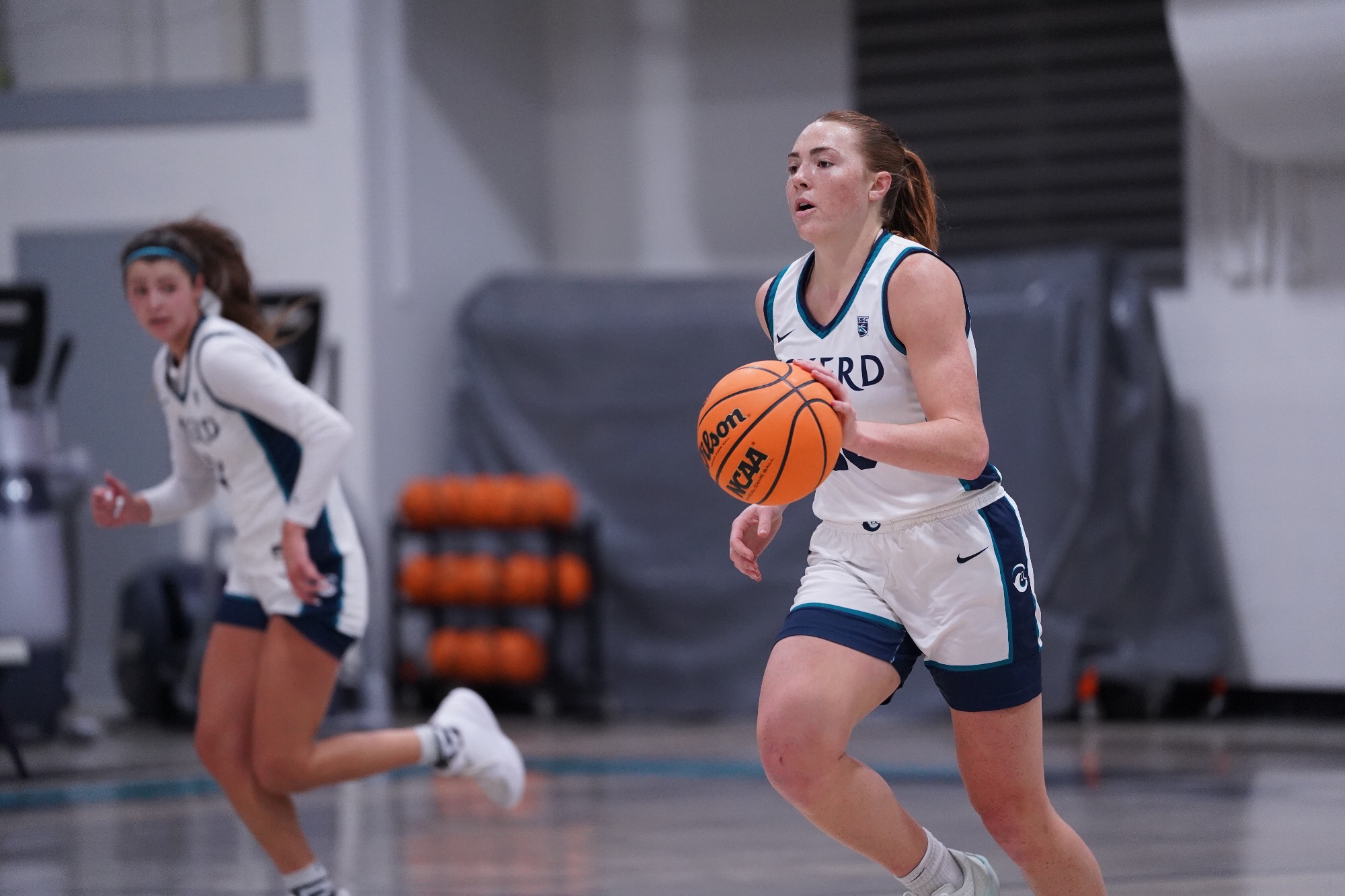 Player dribbles ball up floor
