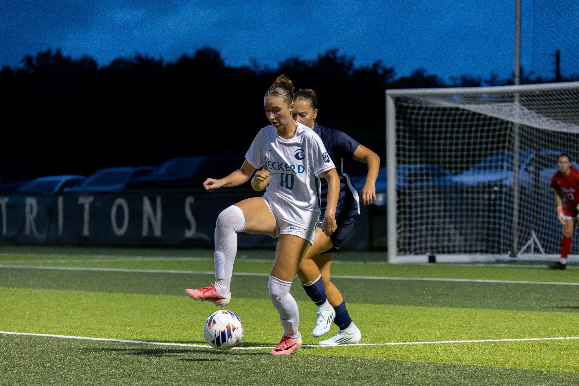 player battles defender for ball