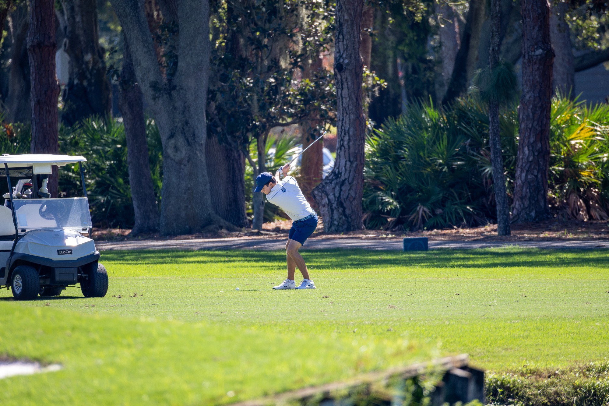 player swings club