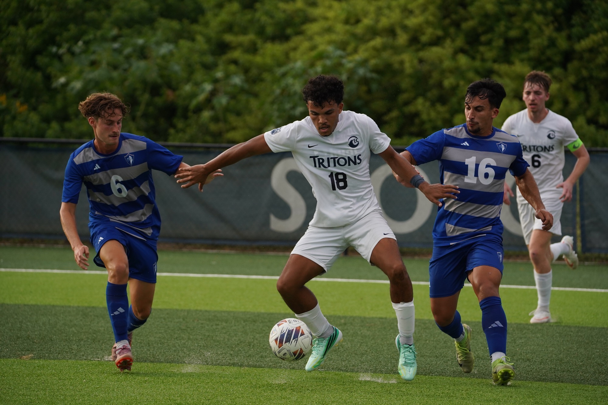 Player dribbles between two defenders