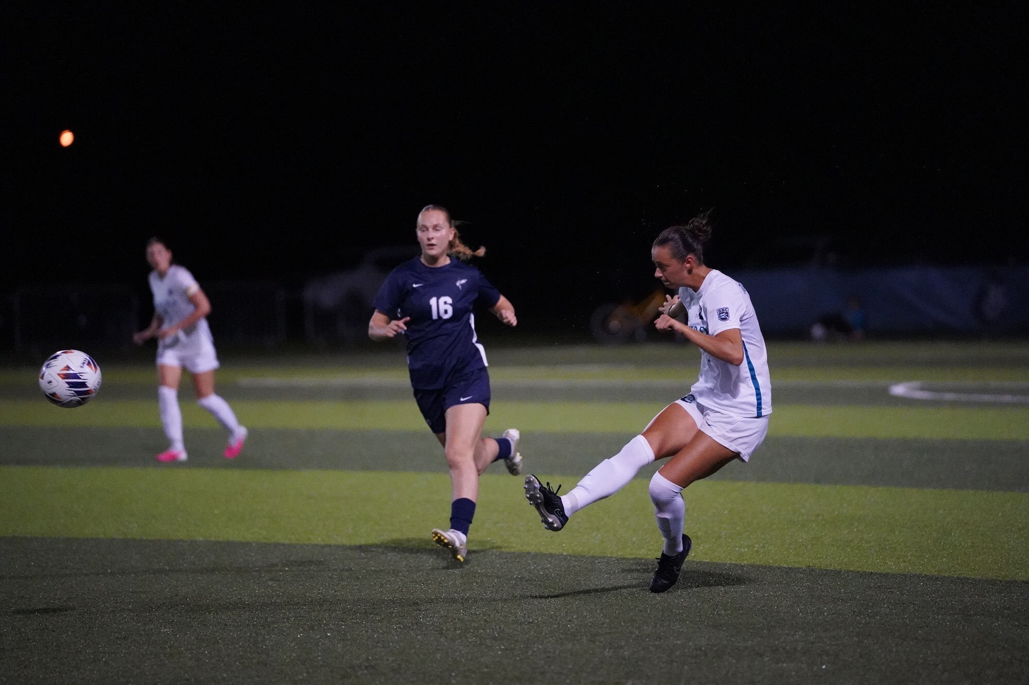 player kicking ball up field
