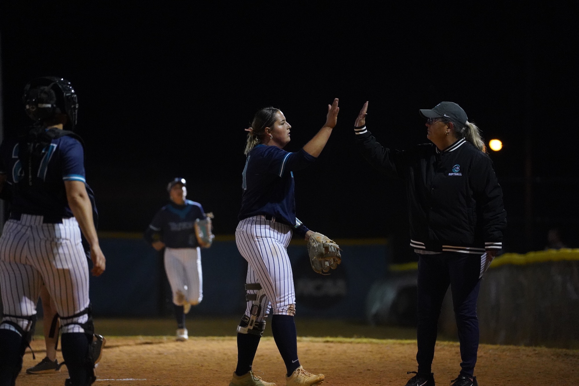 Pitcher and coach high five