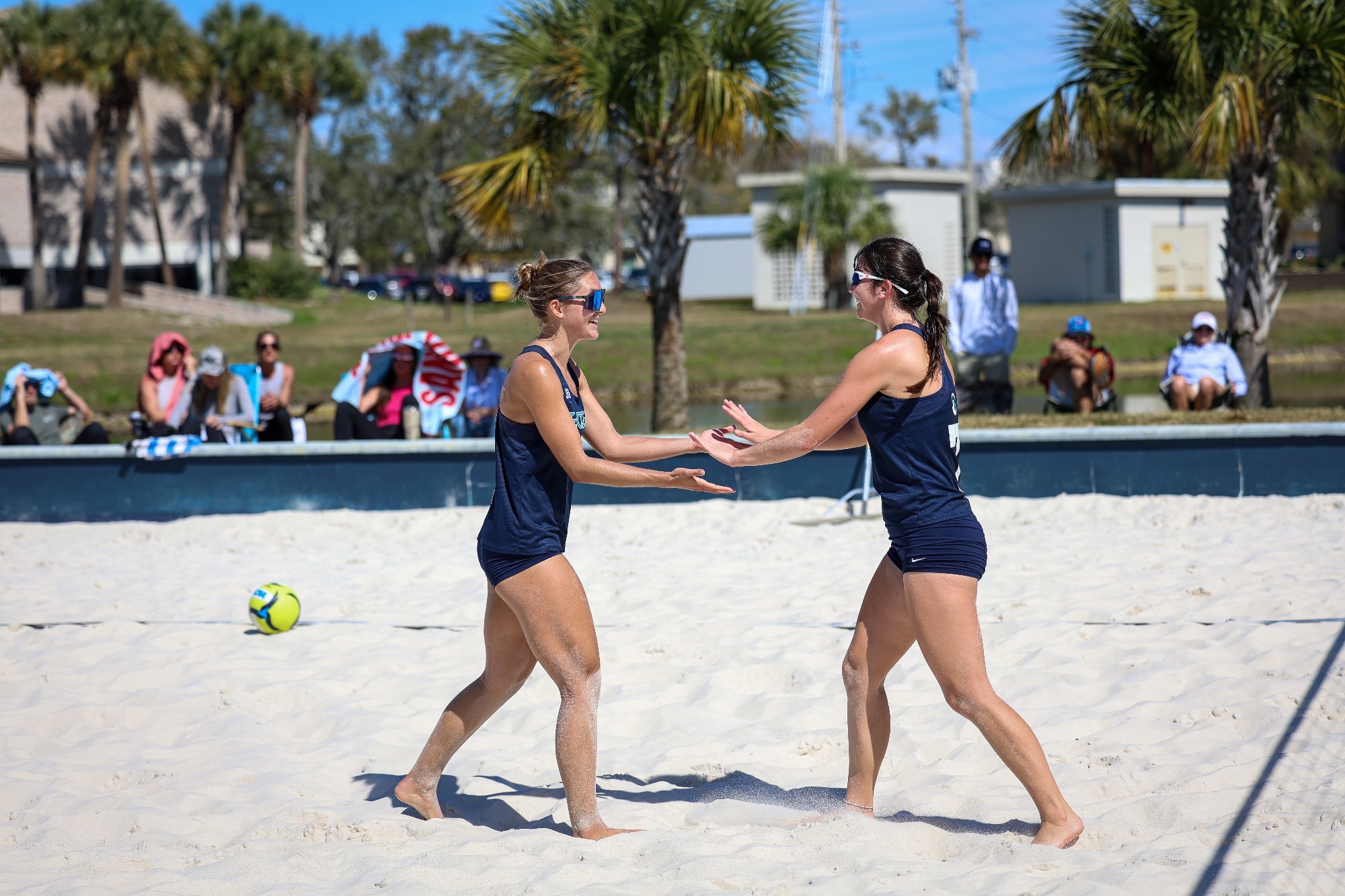 Two players high five after point