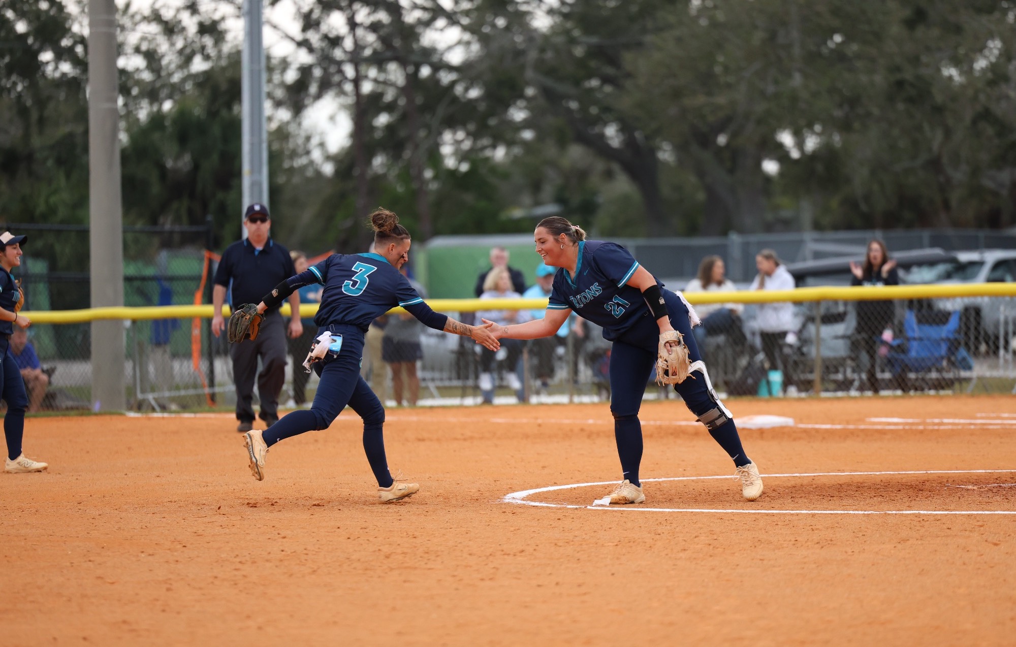Players high five at pitcher's mound