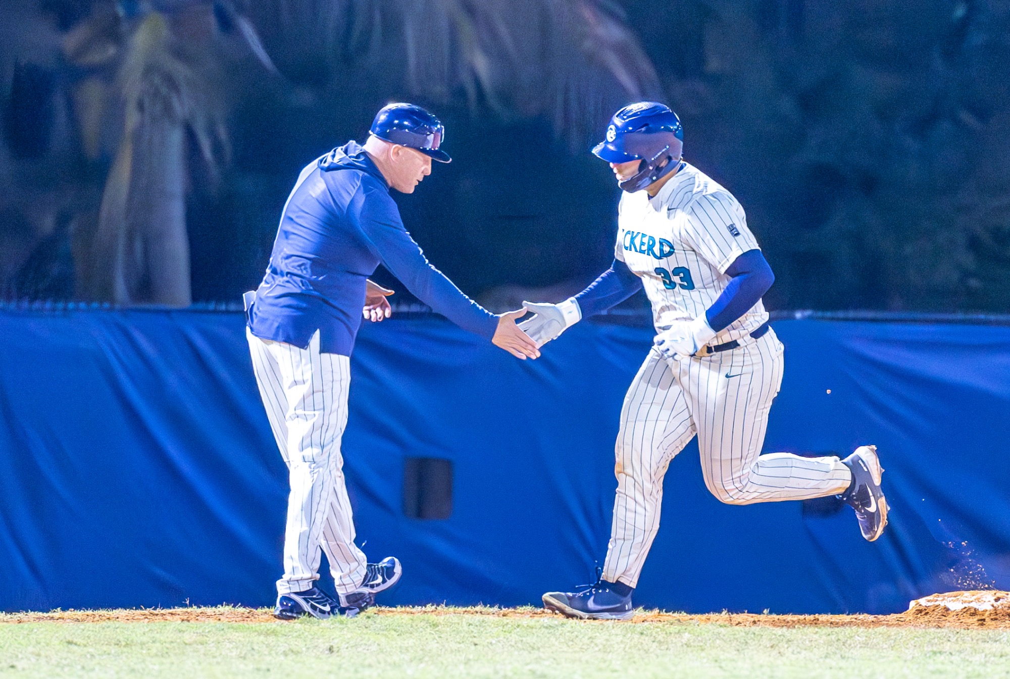 Coach and player celebrate after home run