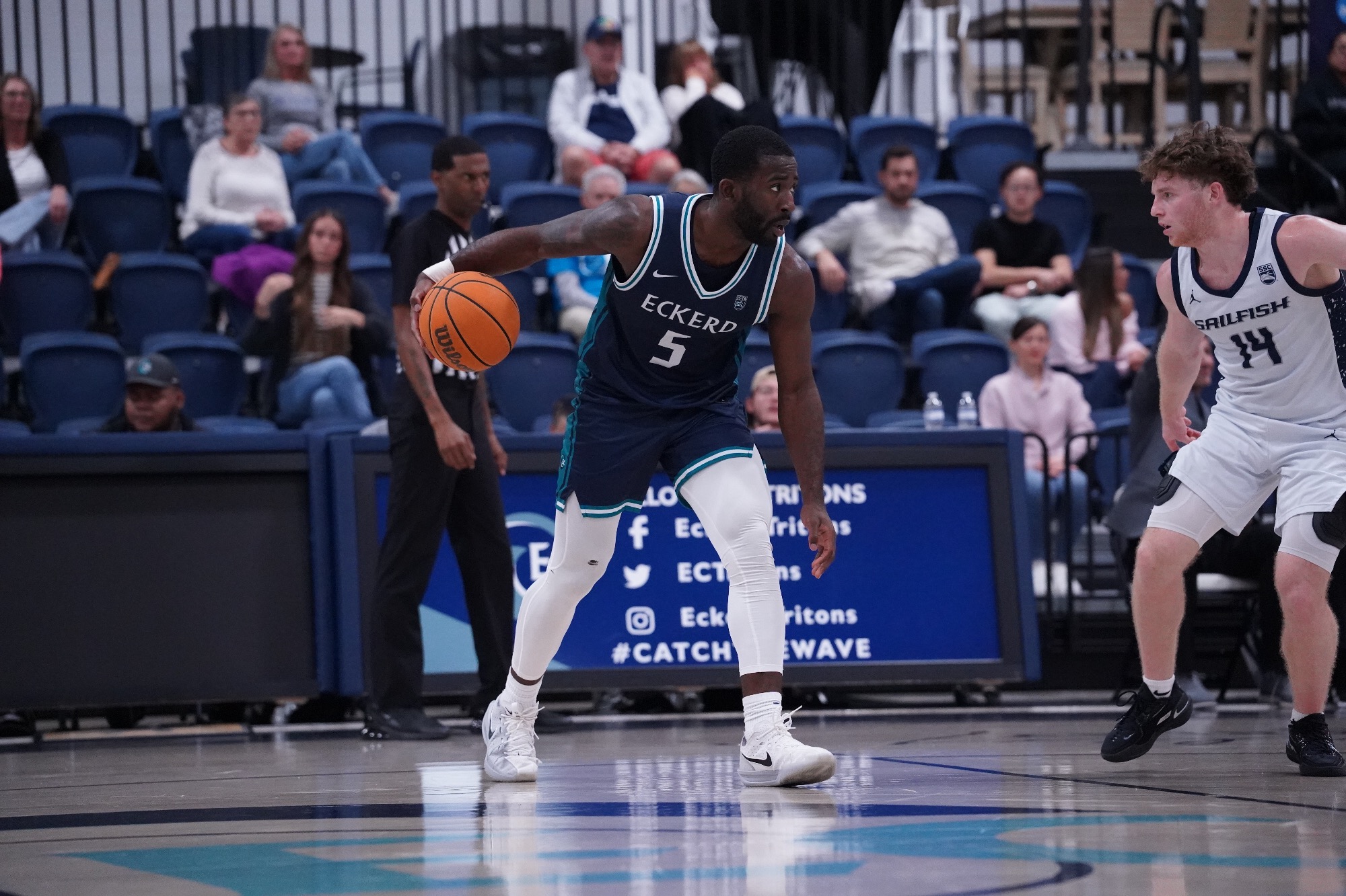 Player dribbles ball while being defended