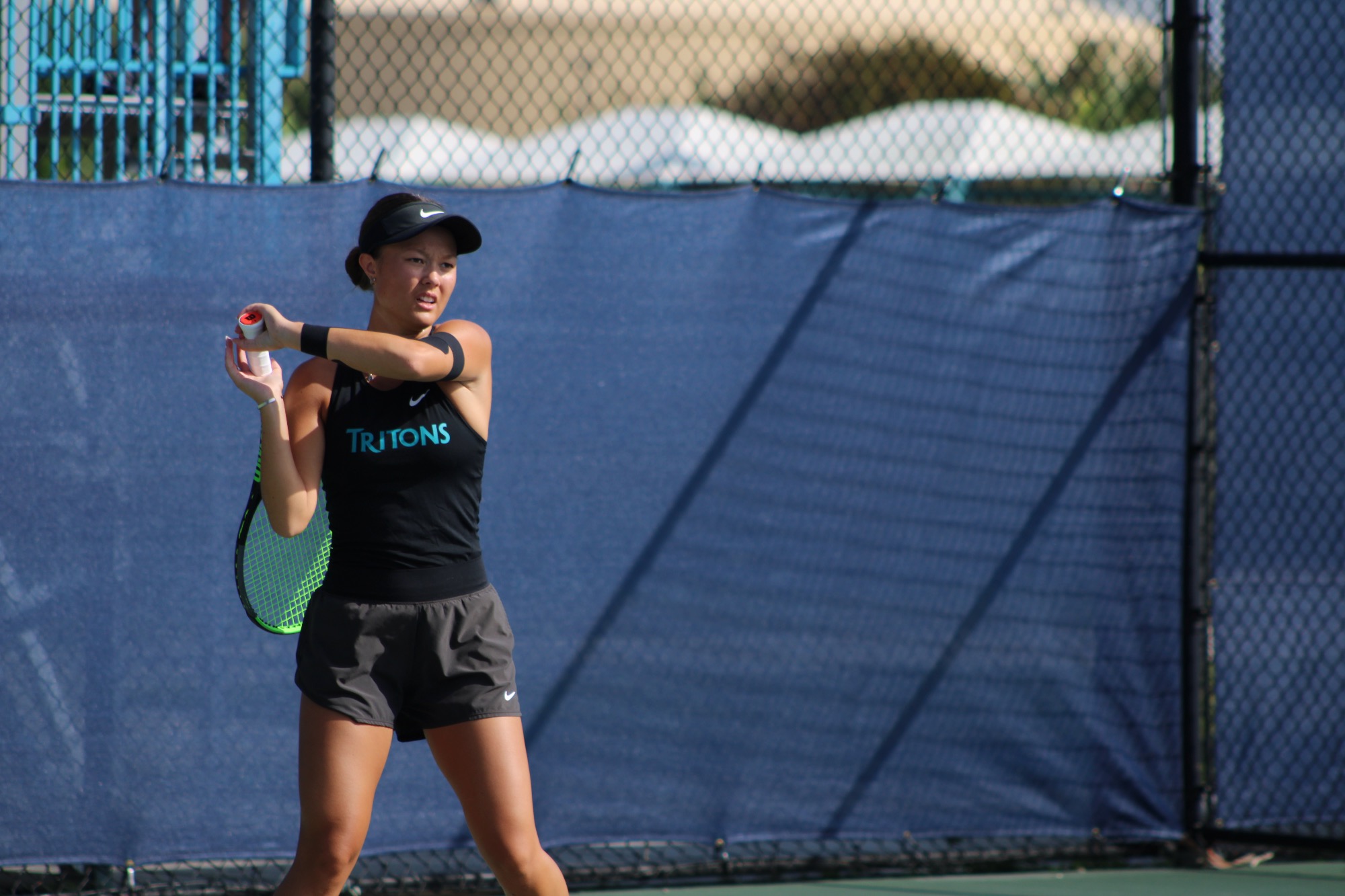 Player backhands ball