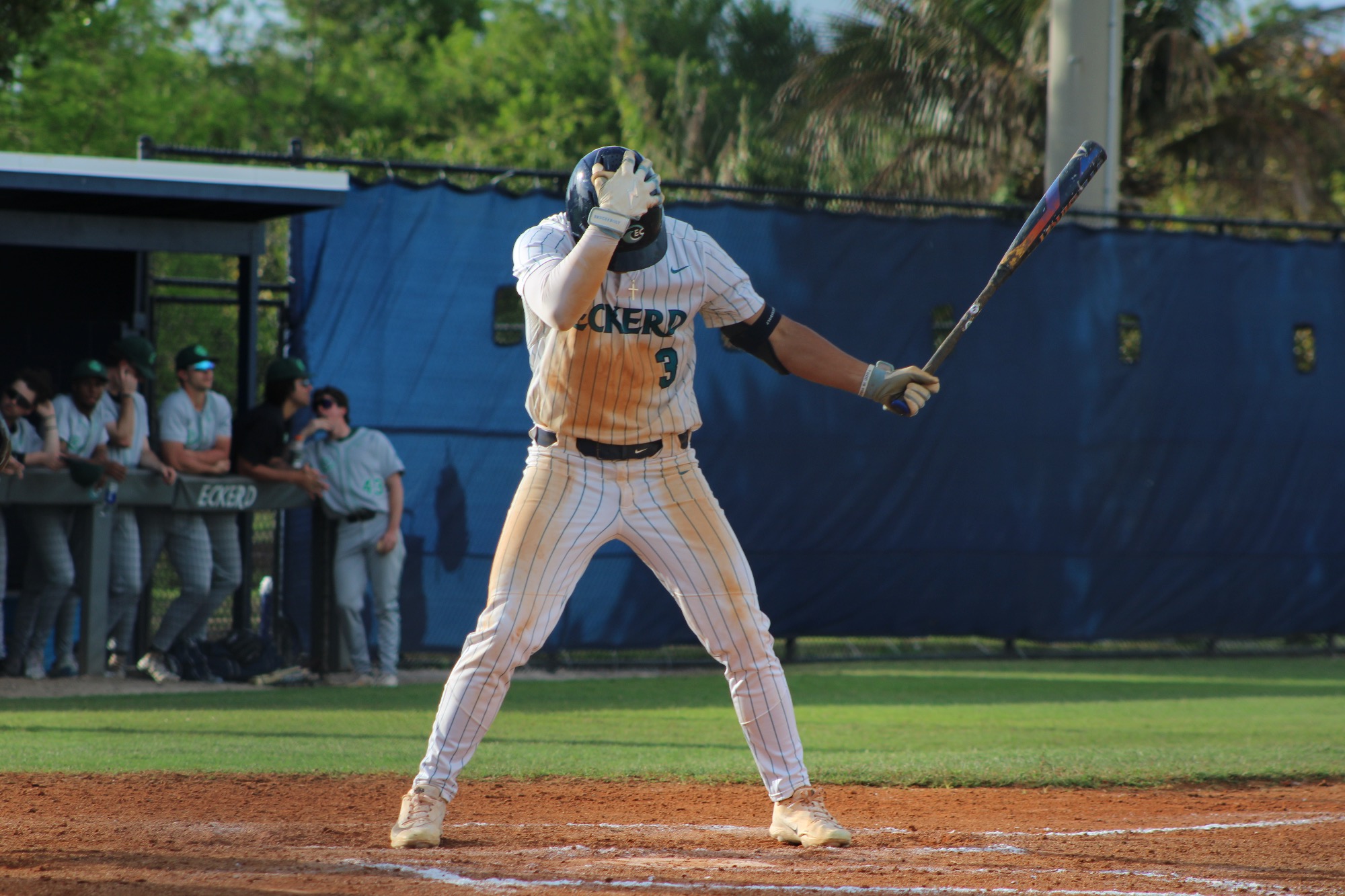 Player taps helmet before pitch