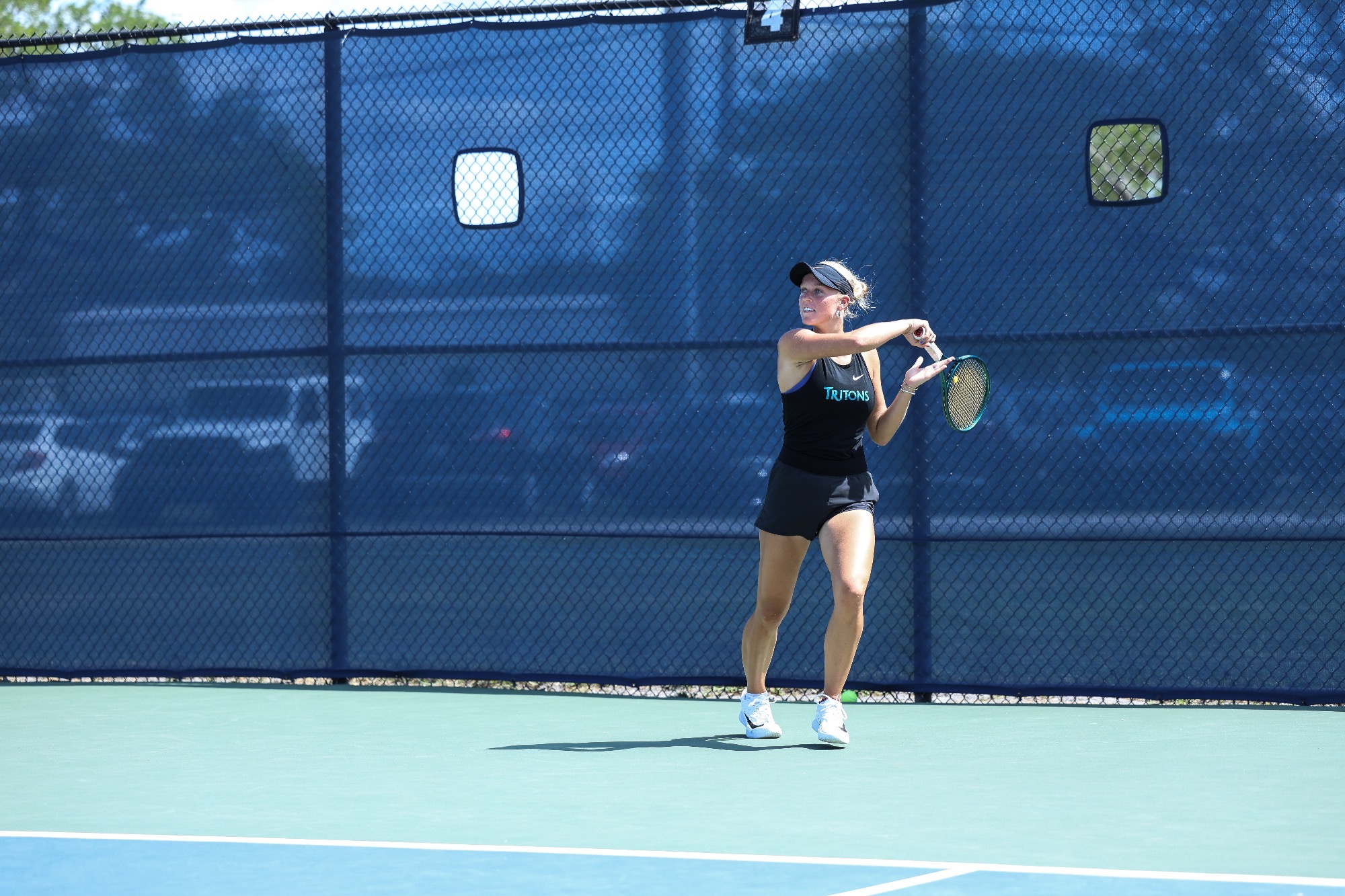 player swings racket