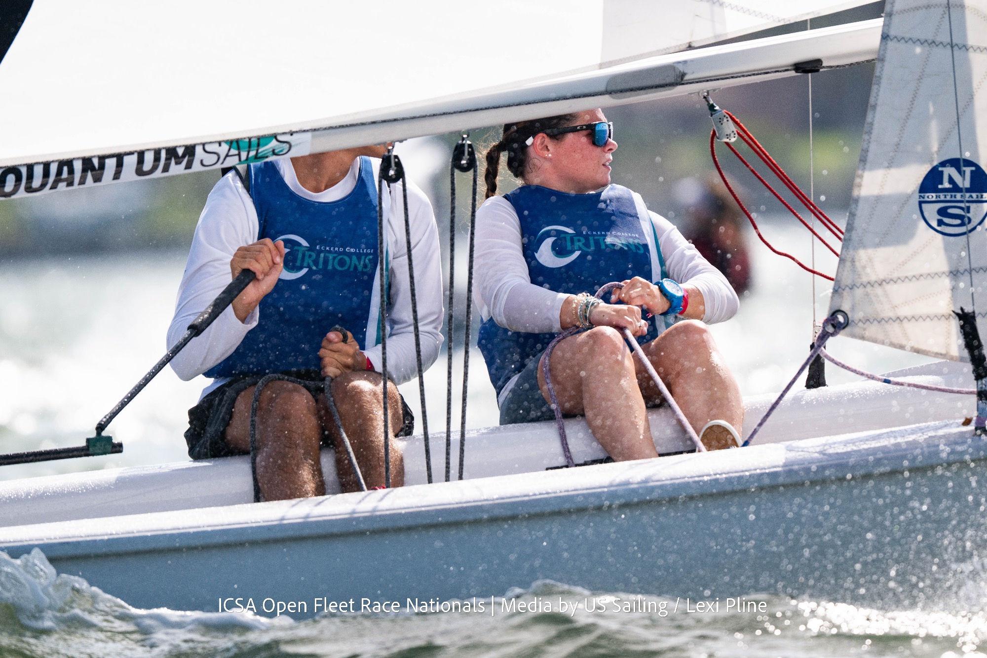 Sailors sit on edge of boat