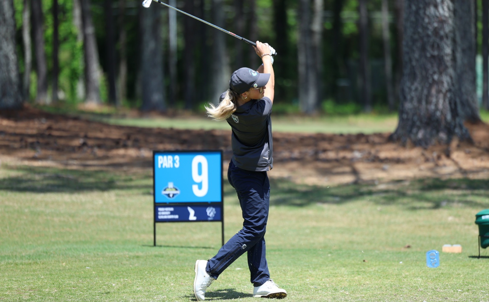 golfer swings club