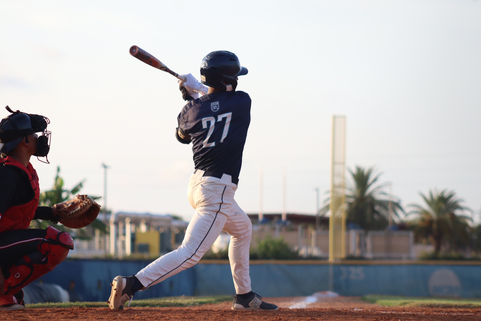 player swings bat