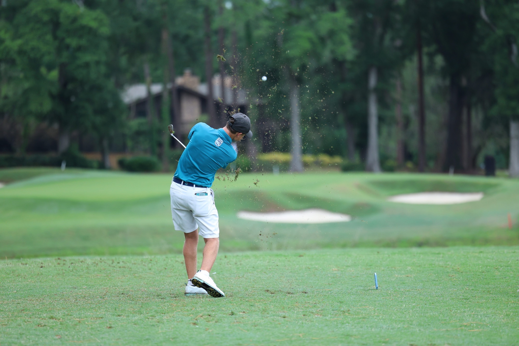 player swinging club