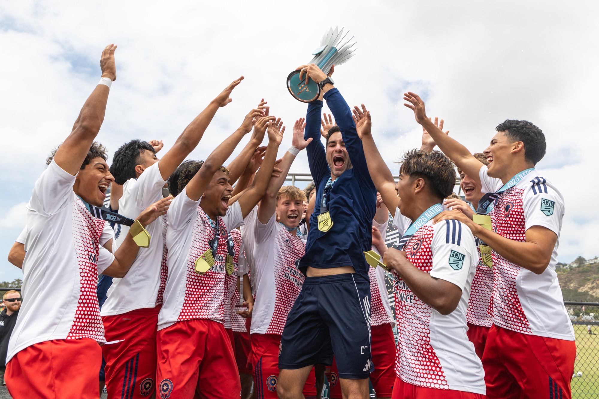 Tulsa SC celebrates their national championship by raising a trophy and jumping up and down