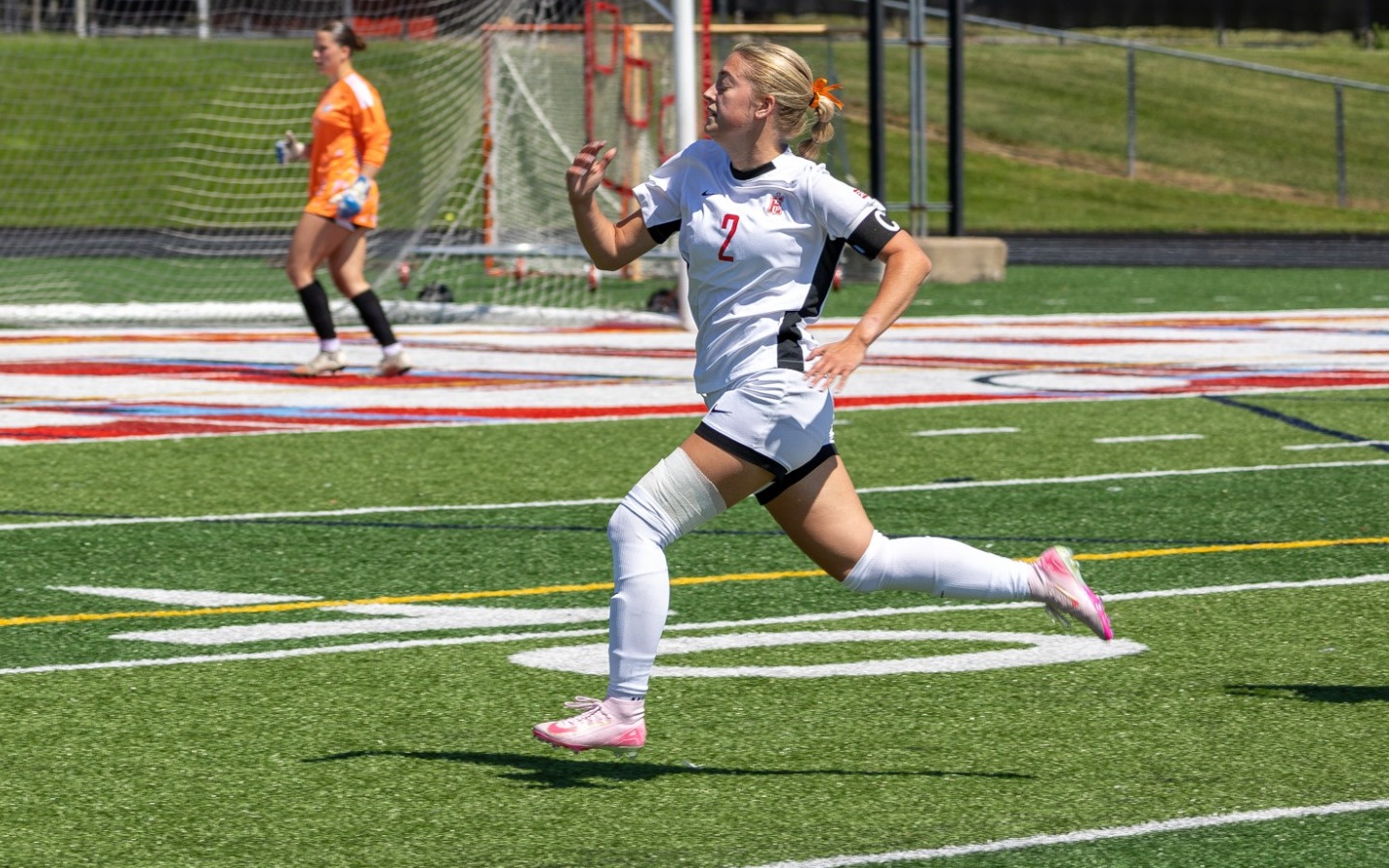 Elise Cacchione chases down pass on the sideline