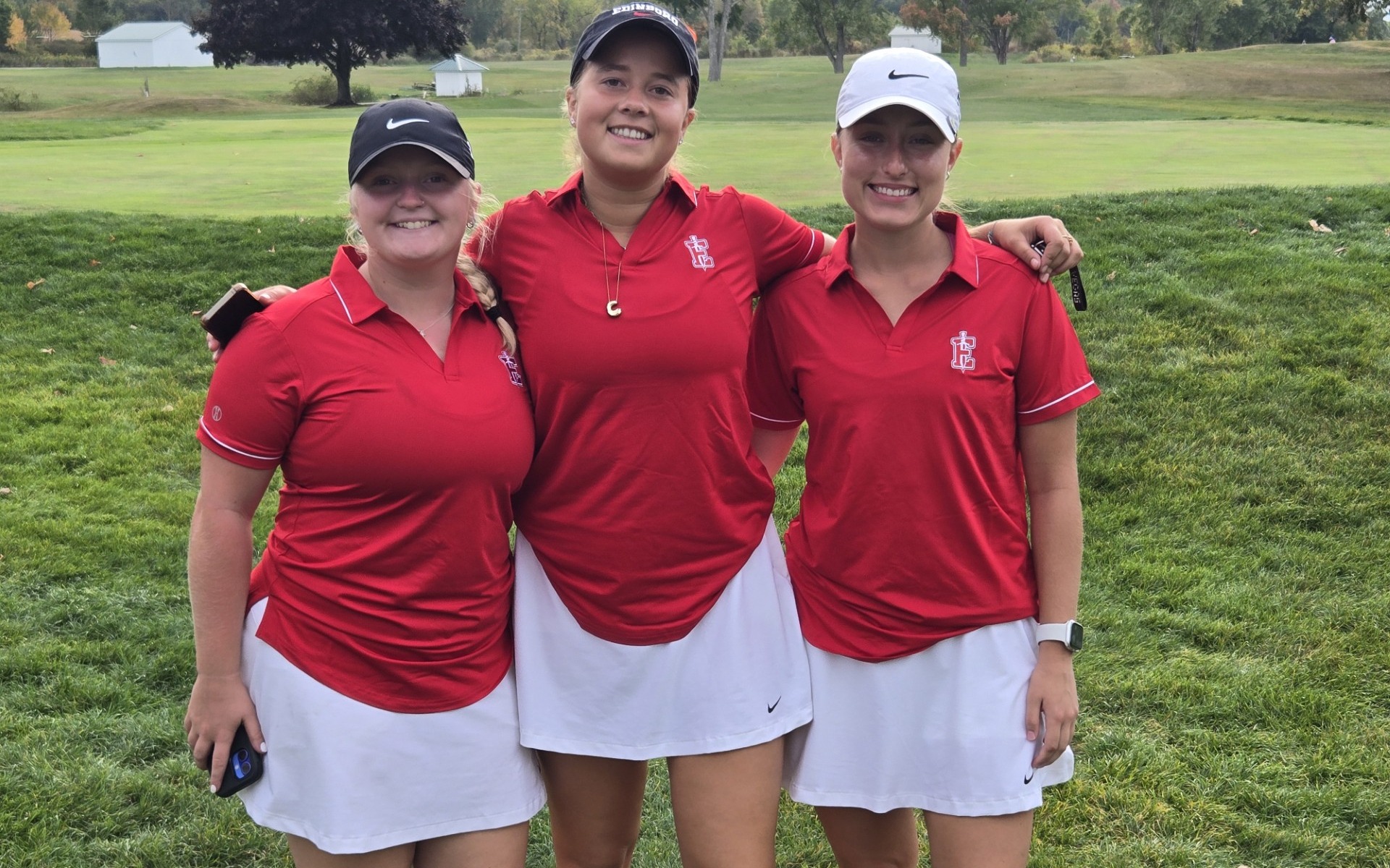 Edinboro women's golfers Cecelia Carayol, Haley Sliker and Jocelyn Williams pose post round.