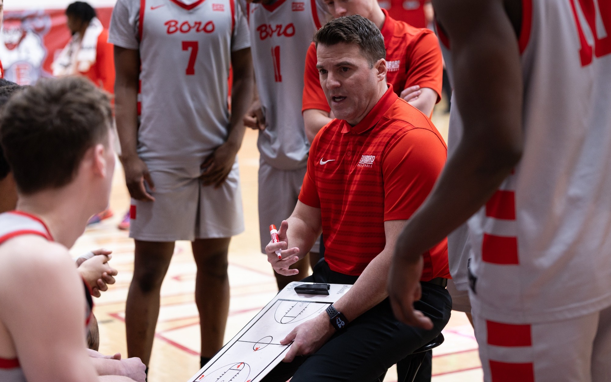 Justin Jennings leads the team huddle during a timeout