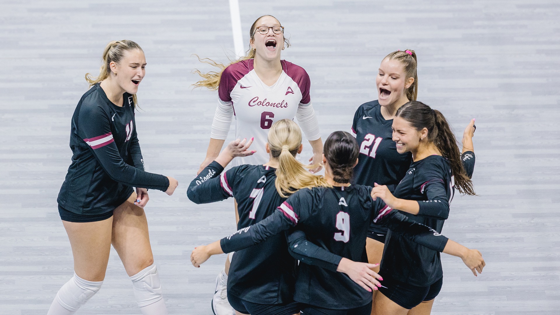 A group of players celebrate on the court against IU Indy