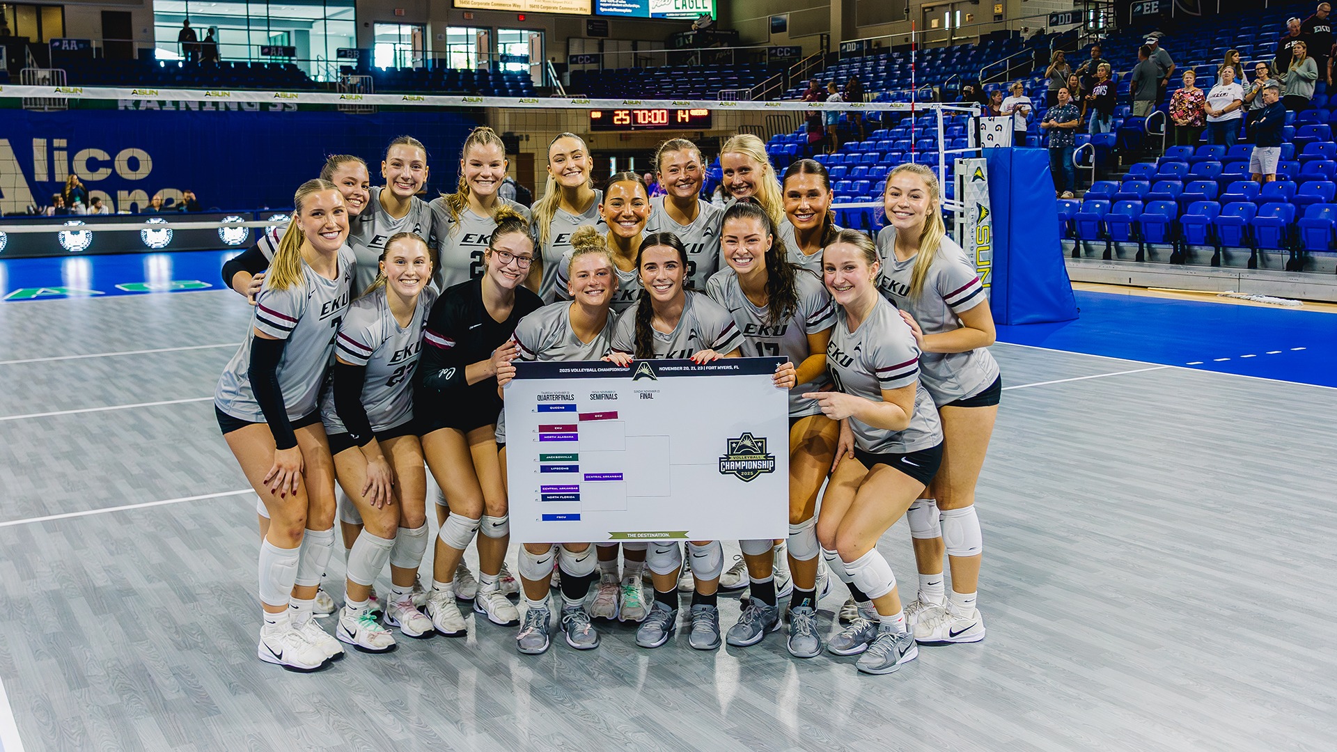 The EKU volleyball team poses for a photo with the bracket after beating Queens in ASUN Tournament