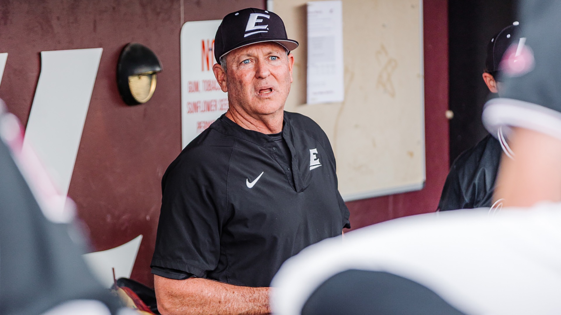 Jan Weisberg talks to the team in the dugout after a win over Illinois State