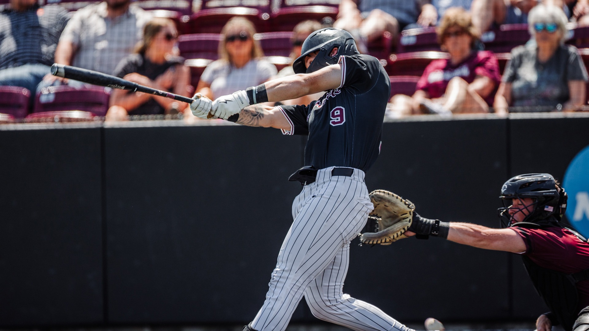 Tyler Phillips swings at a pitch against Bellarmine