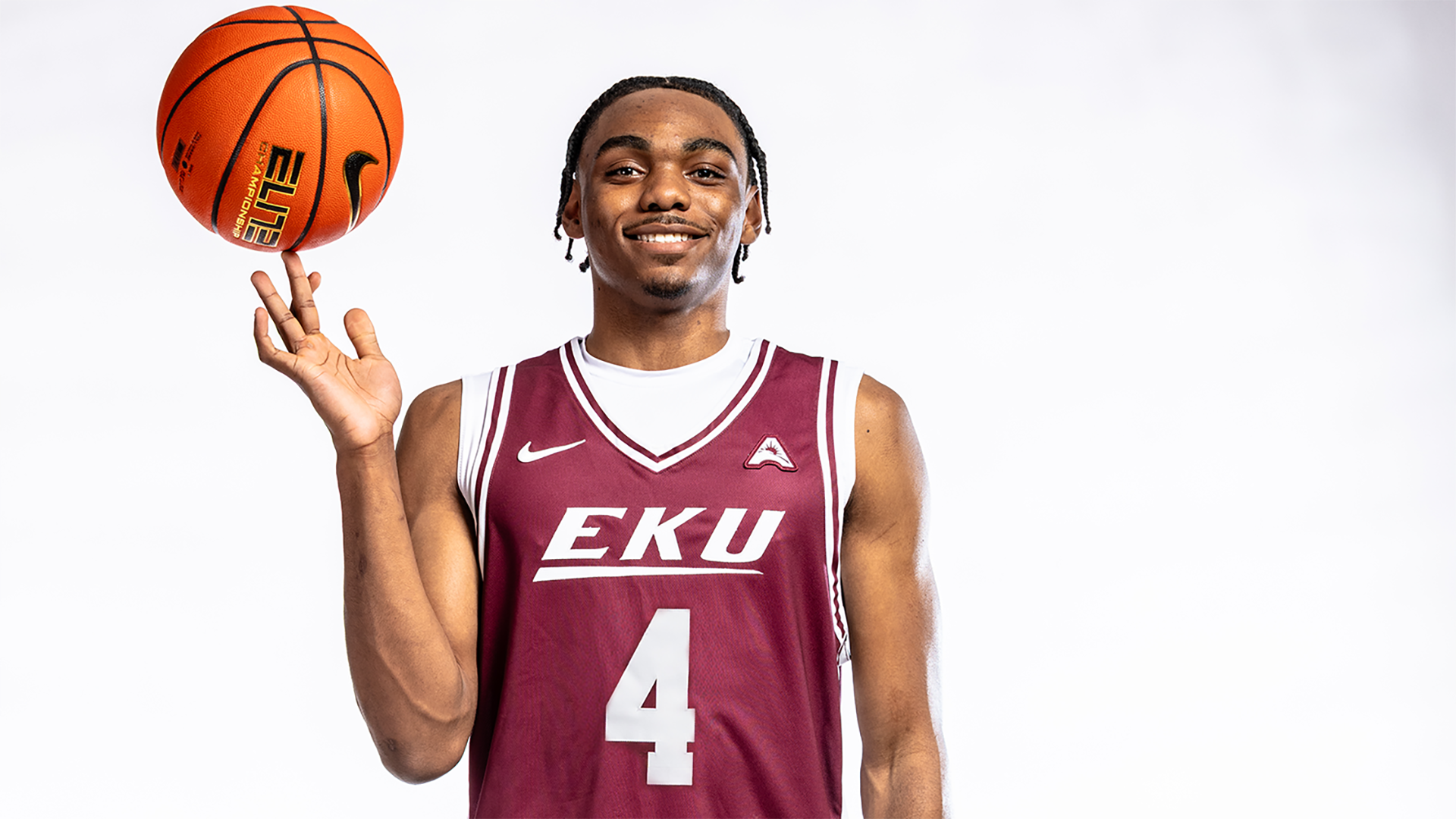 Josh Lowe poses with a basketball spinning on his finger
