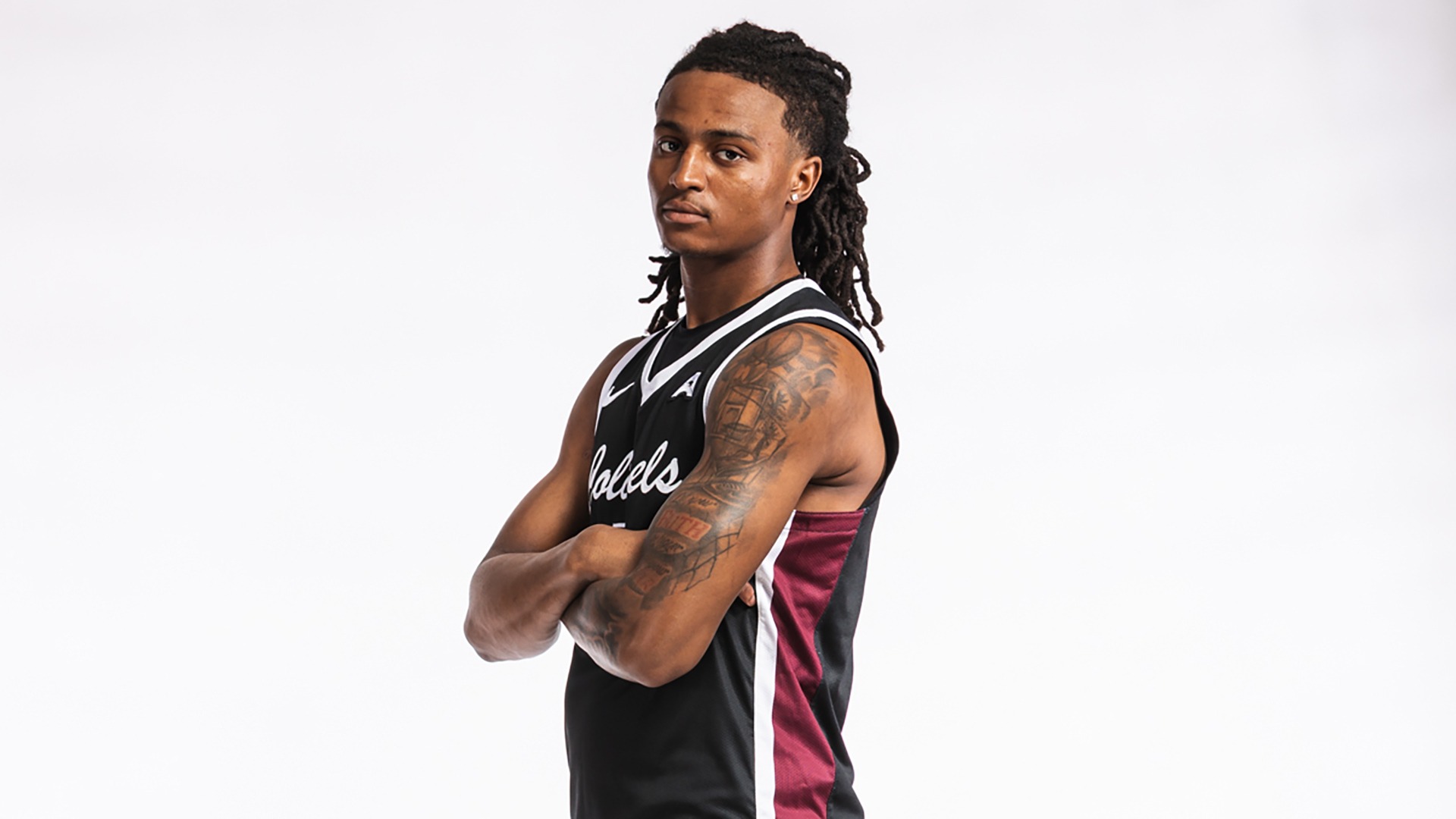 Damone King poses for a photo in a black uniform