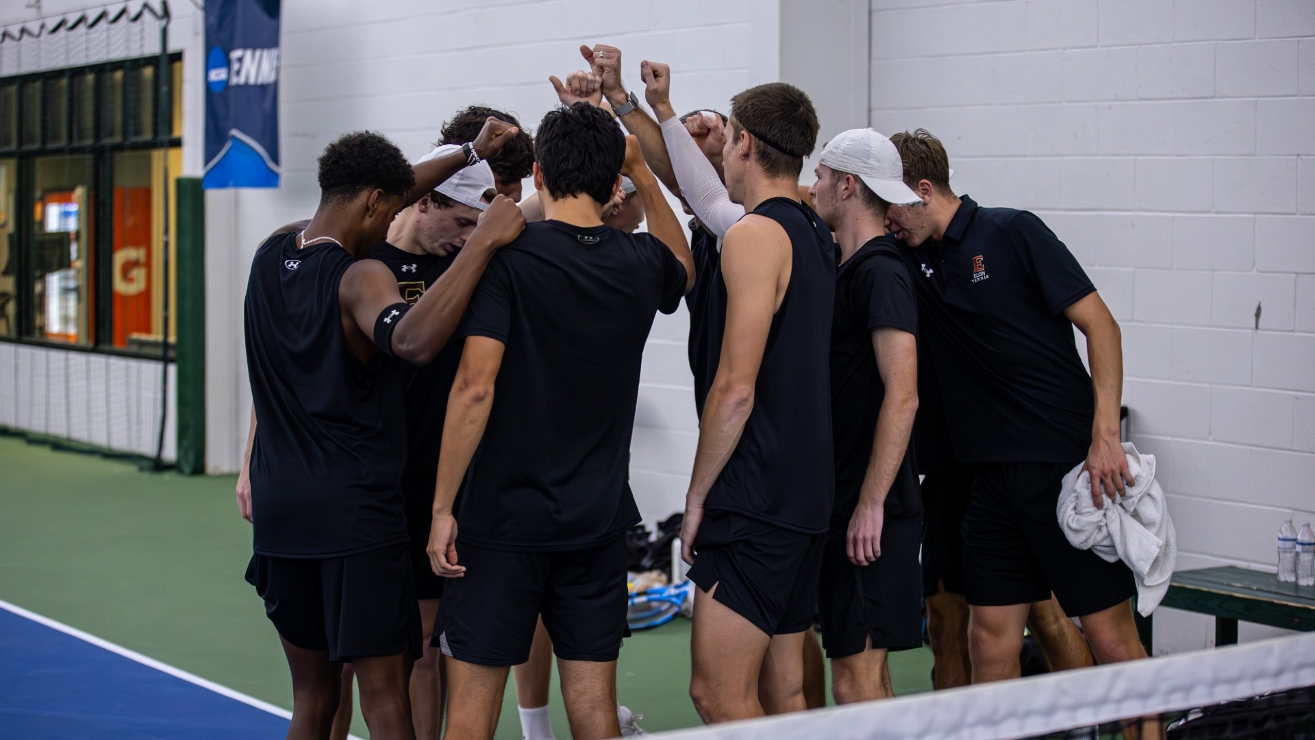 Men's tennis huddle vs. Saint Joe's