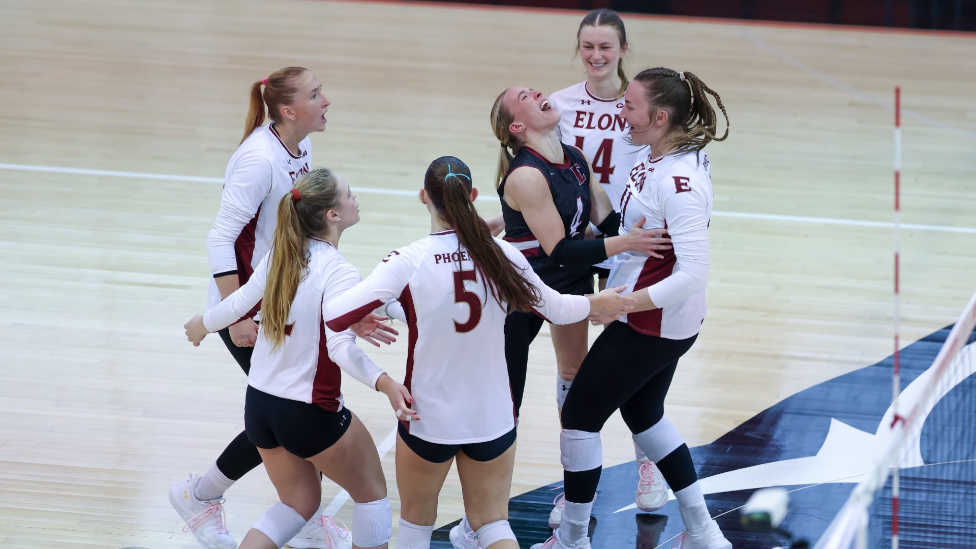 Elon Volleyball celebrates versus Northeastern on Oct. 10