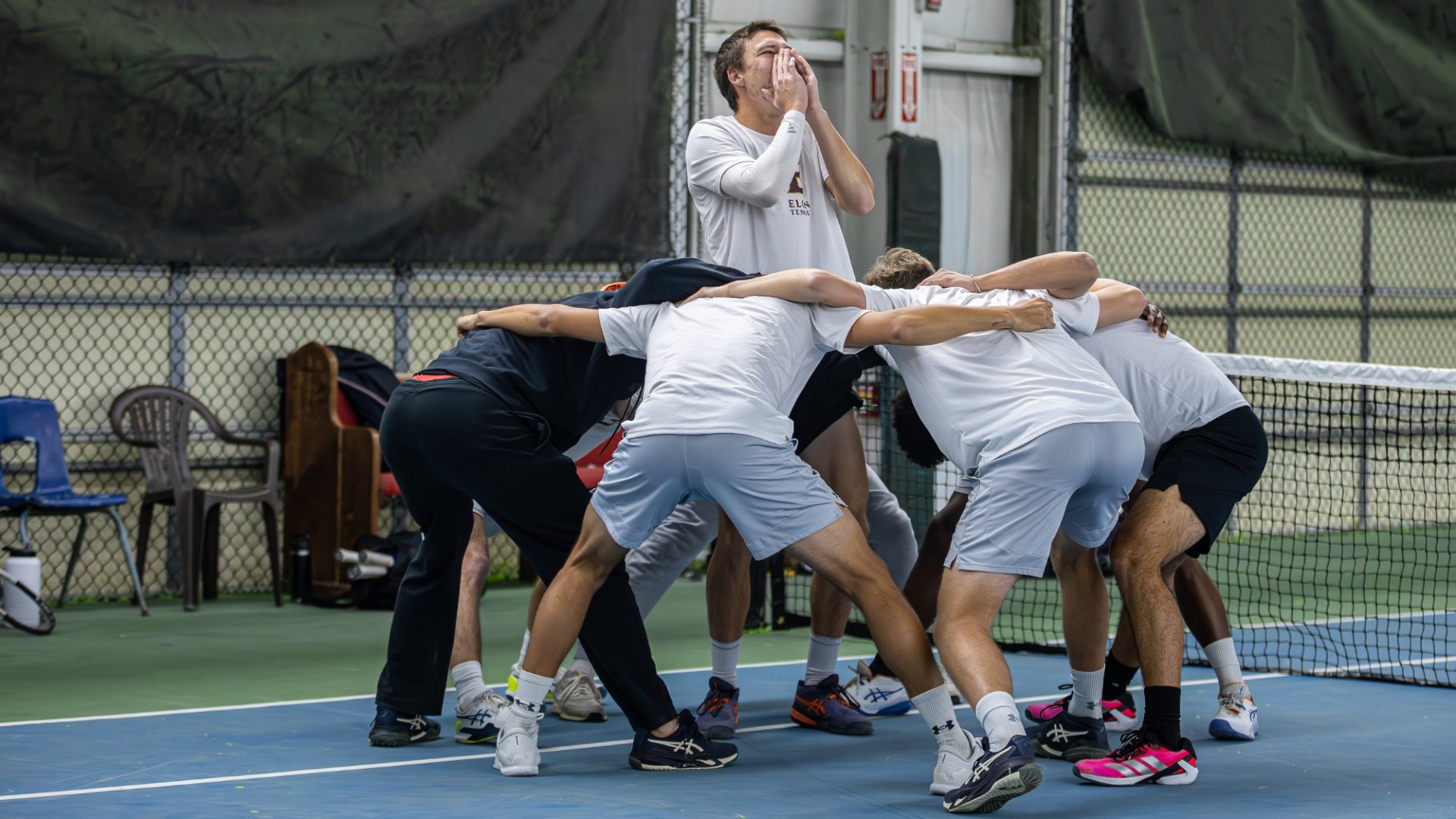 Men's Tennis huddle vs. UNCG
